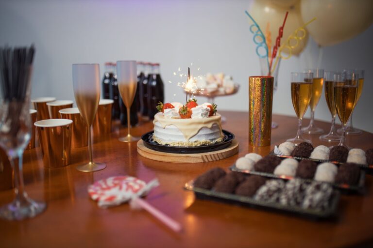 A vibrant Brazilian birthday party setup with cake, sparkling decorations, and desserts.