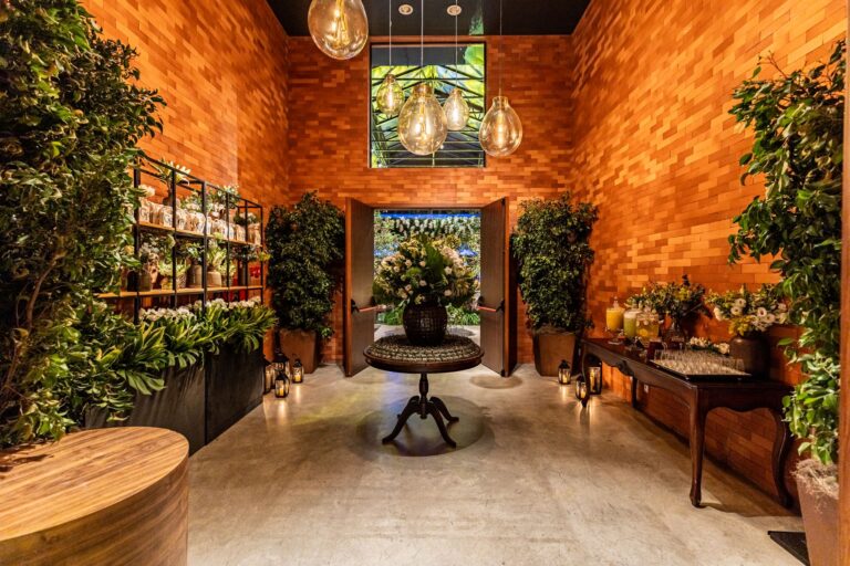 Cozy indoor restaurant setting with floral decorations and ambient lighting, creating a warm and inviting atmosphere.