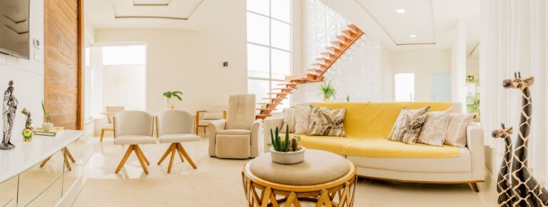 Modern interior of cozy spacious living room with light furniture with wooden elements