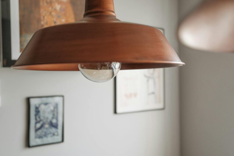 A contemporary close-up of a brown hanging lamp with soft ambient lighting indoors.