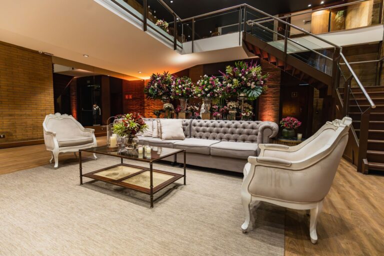 Luxurious hotel lobby featuring a classic sofa set and elegant floral arrangements.