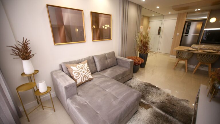 A luxurious modern living room with a stylish grey sofa and elegant decor.