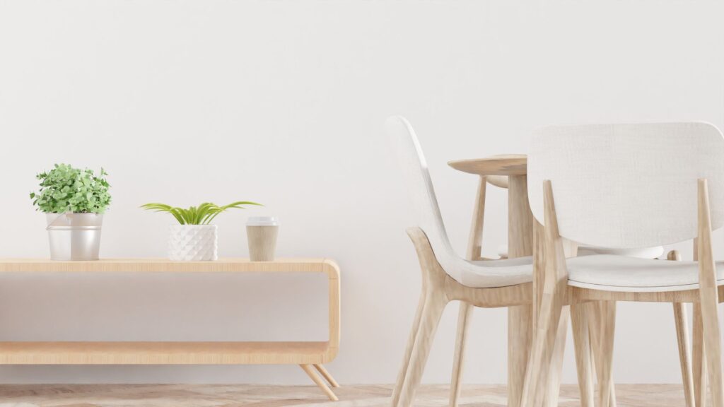 Clean and modern dining area showcasing light wooden furniture and indoor plants.