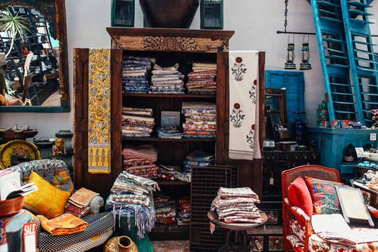 An intricate display of colorful textiles and home decor in a vintage store interior setting.