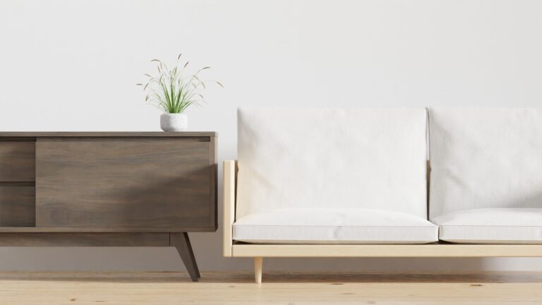 A minimalist living room features a chic wooden console with a potted plant and a cozy beige sofa.