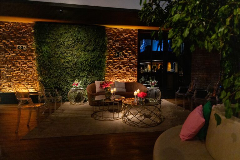Cozy indoor lounge featuring elegant sofas, ambient lighting, and vibrant decor accents.