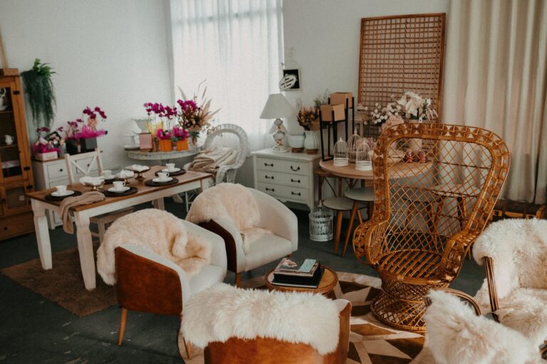 A stylish living room featuring modern furniture, cozy fur throws, and vibrant plants for a warm atmosphere.