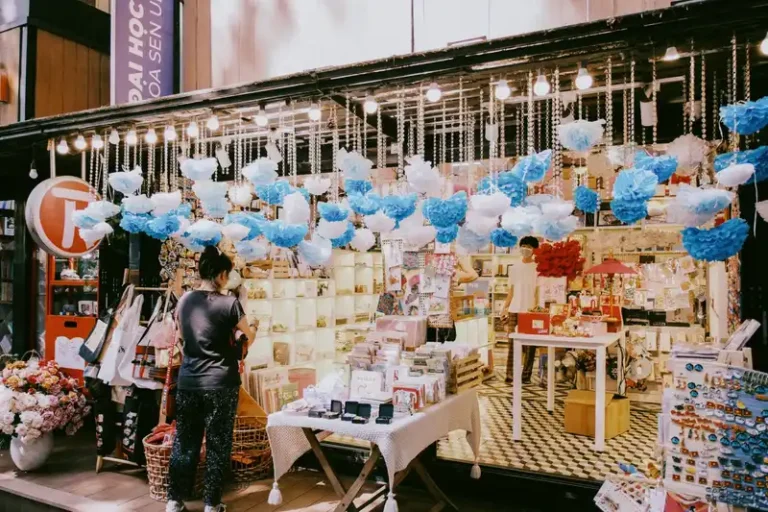 Charming gift shop with floral decor and trinkets in a bustling Saigon street market setting.
