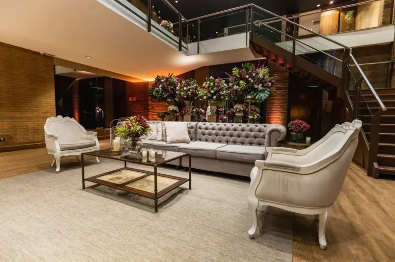 Luxurious hotel lobby featuring a classic sofa set and elegant floral arrangements.