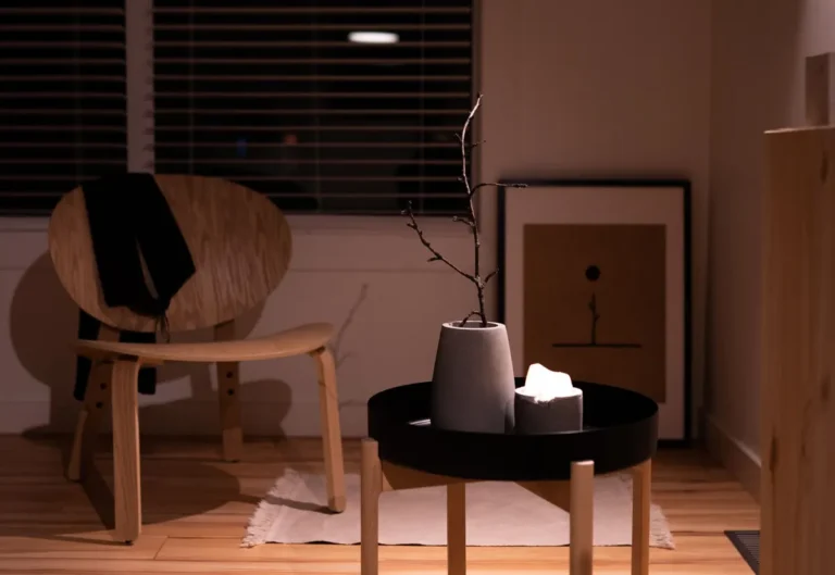Cozy minimalist interior featuring a wooden chair, coffee table, and stylish decor elements.