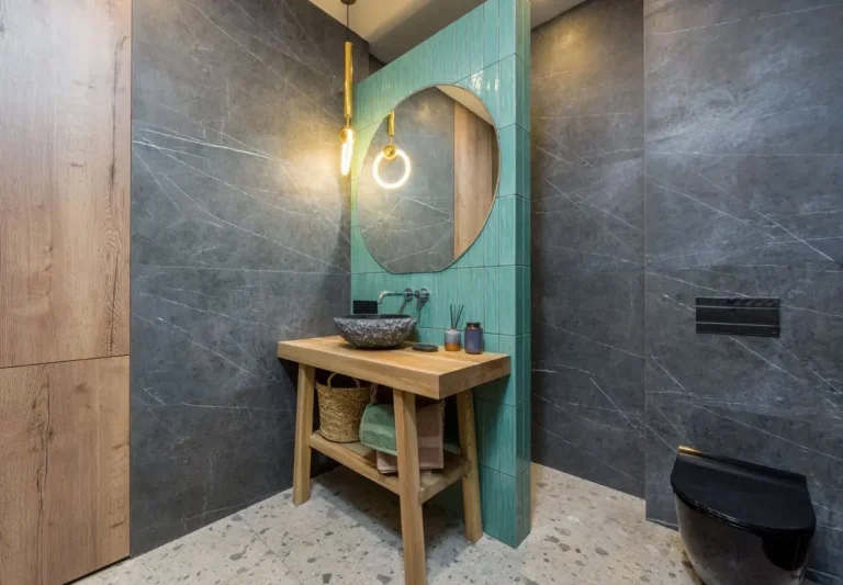 Stylish bathroom featuring a unique mirror and elegant decor elements.