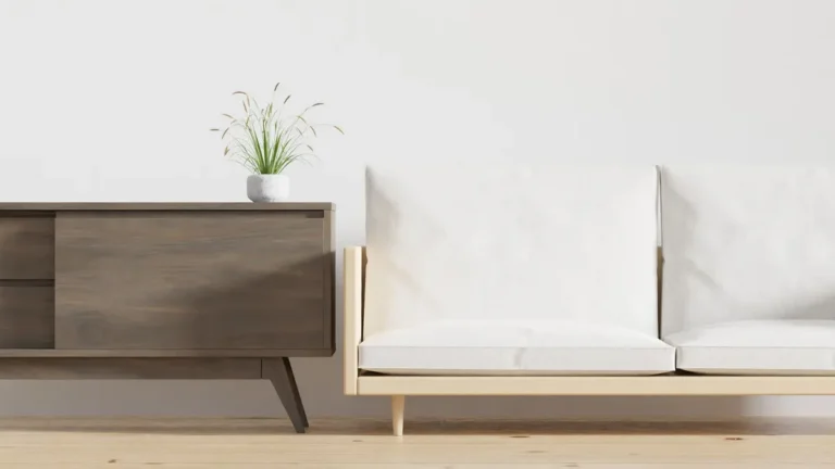 A minimalist living room features a chic wooden console with a potted plant and a cozy beige sofa.
